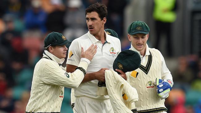 Australian captain Steve Smith (left) reacts with Mitchell Starc after he dismissed South African batsman Stephen Cook for 34 runs on day one of the 2nd Test match between Australia and South Africa at Bellerive Oval in Hobart, Saturday, Nov. 12, 2016. (AAP Image/Dave Hunt)