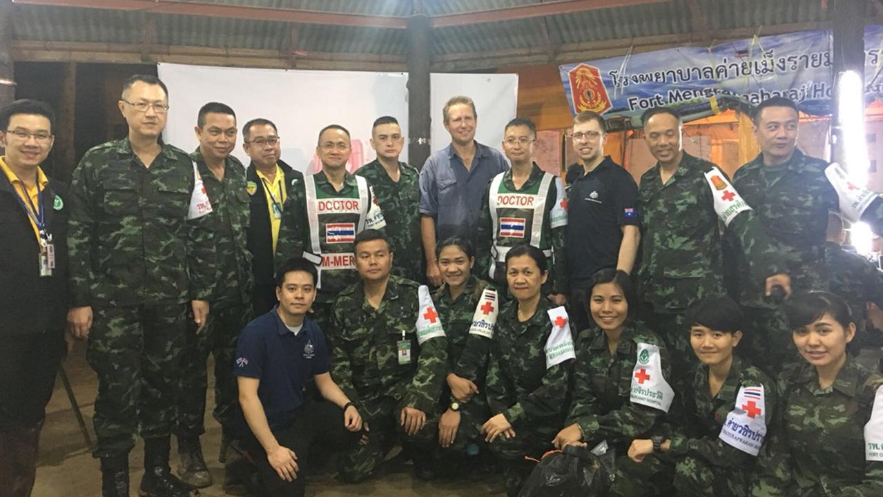 A supplied image obtained on Wednesday, July 11, 2018, of Australian doctor Richard Harris (centre), and the medical team he worked with to assist in the rescue of 12 Thai boys who were stuck in an underground cave with their soccer coach, but have since been rescued. (AAP Image/Supplied by DFAT)