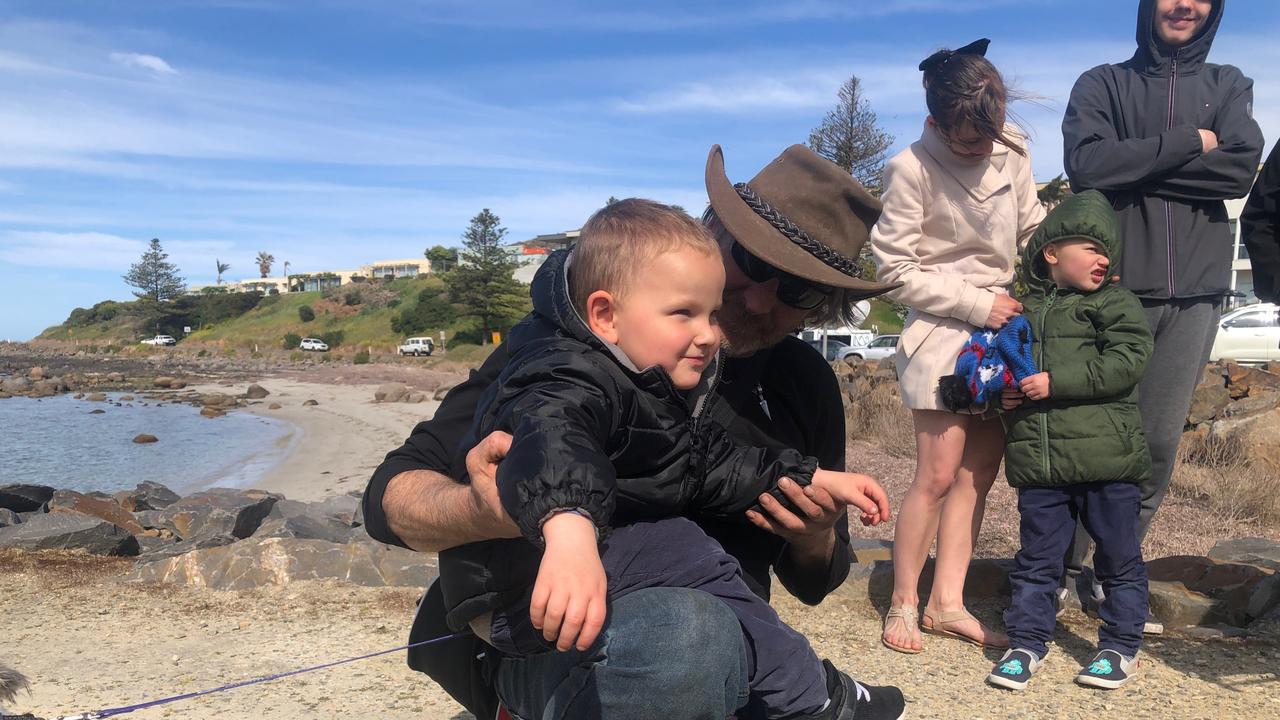 Derek Robinson is reunited with his family as he disembarks on to Granite Island. . Picture: Emily Cosenza