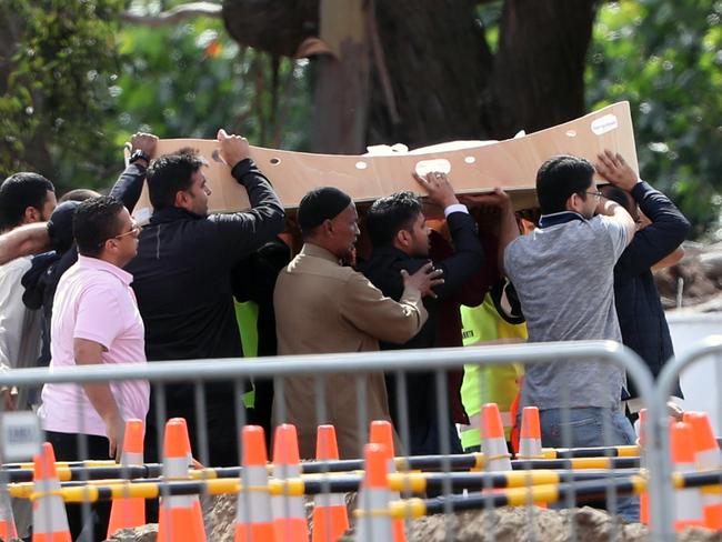 Mourners carry the bodies to the burial area. Picture: Gary Ramage