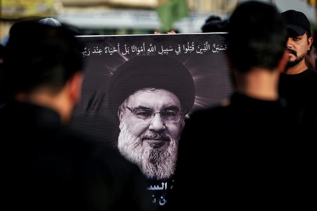 A picture of Hassan Nasrallah, the slain leader of the Lebanese armed group Hezbollah, is displayed during a memorial service in Baghdad's eastern suburb of Sadr City