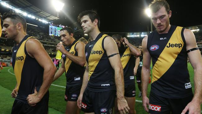 Richmond players walk off the MCG after losing on Friday night.