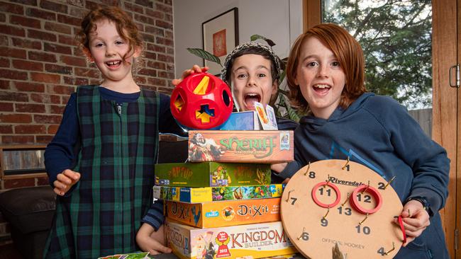 Siblings Frankie, 5, Elliot, 11 and Gabe, 8, love their toy library toys. Picture: Jason Edwards