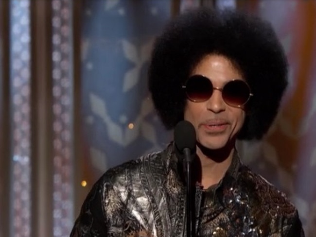 Prince hits the stage, delighting the crowd with his afro.