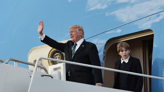 Don’t wave goodbye, he’s not going anywhere. Donald Trump and his son Barron step off Air Force One in Florida. (Pic: Mandel Ngan/AFP)