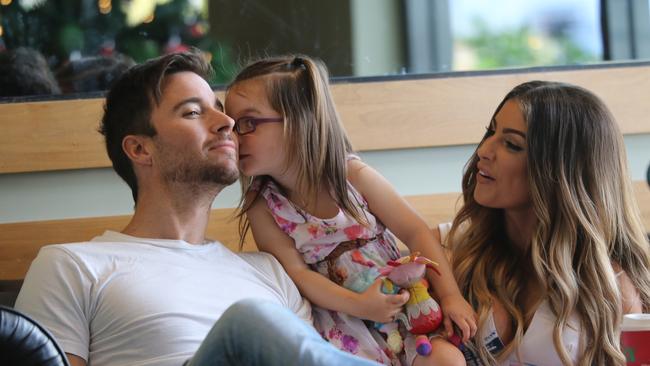 Michael Turnbull, his girlfriend Katrina Vincent and her daughter Ava seemed blissfully happy at a Brisbane cafe earlier this month. Picture: INFphoto.com