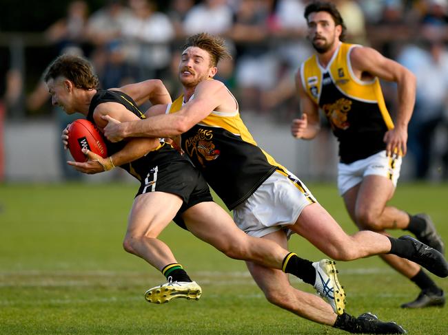 Jake Aarts of the Tigers is tackled by Brenton Lambert of the Stonecats during the 2023 MPFNL Division One Seniors Grand Final match between Dromana and Frankston YCW at Frankston Park in Frankston, Victoria on September 17, 2023. (Photo by Josh Chadwick)