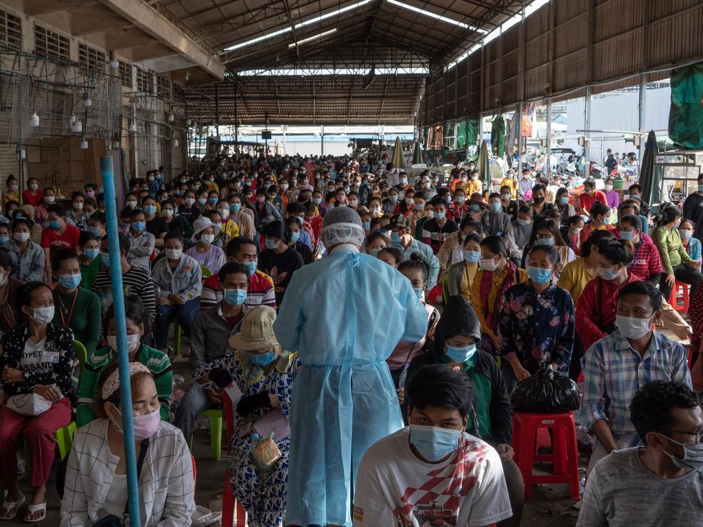 Health workers begin the task of testing around 500 people for coronavirus in Cambodia.