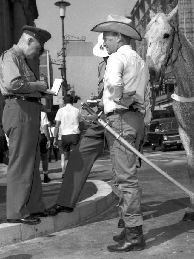 1968: Police quiz stuntman Mervyn "Bluey" Bostock after he sliced the ribbon with his sword before Alderman Clem Jones could make his official speech opening the new King George Square car park in Brisbane. File picture