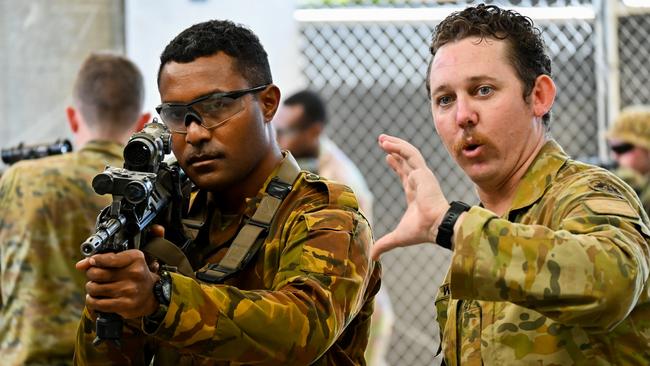 Australian Army Private Ethan Wright, left, conducts weapons training with Papua New Guinea Defence Force Lance Corporal Aurai Vanua at Lavarack Barracks in Townsville in 2021.