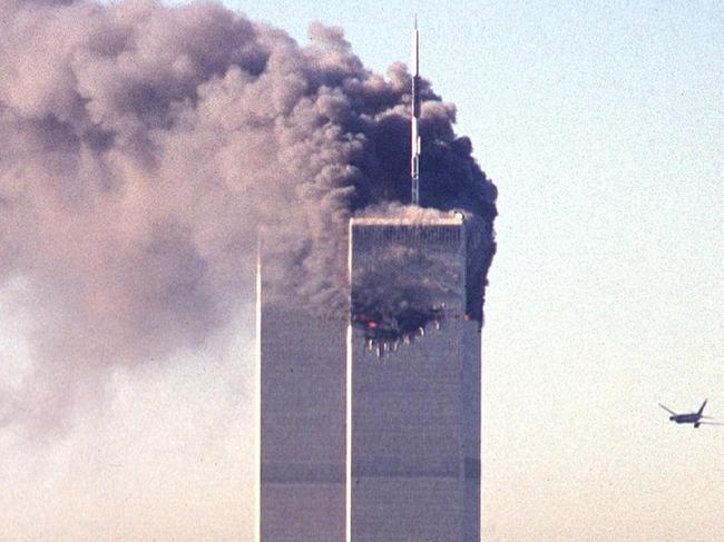 (FILES) In this file photo taken on September 11, 2001, a hijacked commercial aircraft approaches the twin towers of the World Trade Center shortly before crashing into the landmark skyscraper in New York. - The remains of two more victims of 9/11 have been identified, thanks to advanced DNA technology, New York officials announced on September 7, 2021, just days before the 20th anniversary of the attacks. The office of the city's chief medical examiner said it had formally identified the 1,646th and 1,647th victim of the al-Qaeda attacks on New York's Twin Towers which killed 2,753 people. (Photo by SETH MCALLISTER / AFP)