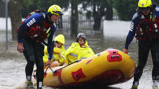 Rochelle Wright and her kids Amelia, 1, and William, 5, are evacuated from their house in Raymond Terrace. Picture by Peter Lorimer.