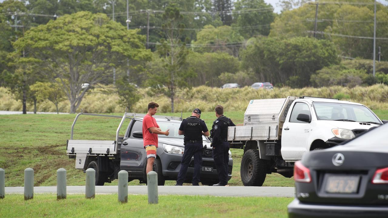 Police talk to driver who drover through flood waters at Emerald Lakes. Picture: Steven Holland