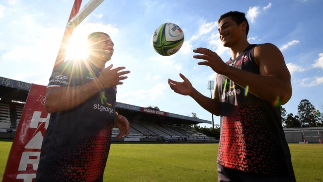 The old and the young of Queensland rugby: 37-year-old George Smith, left, and 18-year-old Jordan Petaia. Both will start for the Reds against the Lions. Picture: AAP