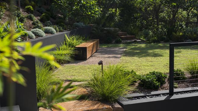 A flat lawn area over the main garage serves as an area for quiet relaxation, a casual place to greet guests or somewhere for the kids to run around under supervision.