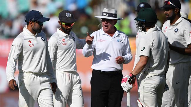 Umpire Marais Erasmus talks to a group of Indian players after another controversial day. Picture: AFP