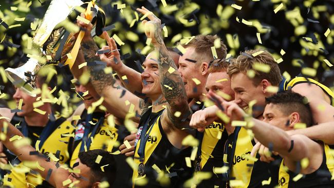 Dustin Martin holds aloft the premiership trophy as his Richmond teammates celebrate. Picture: Mark Metcalfe/AFL Photos/via Getty Images