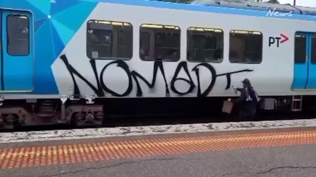 Melbourne Victory hooligan graffitis moving train