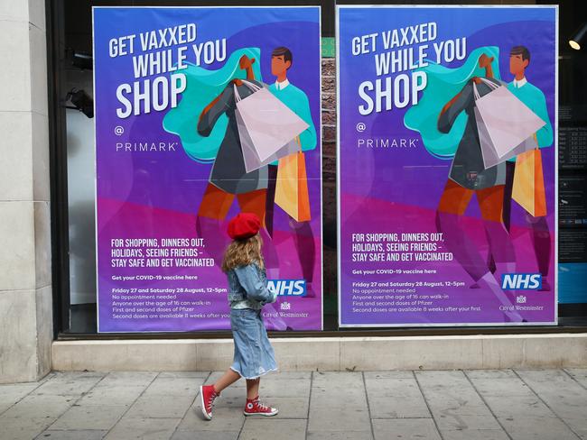 A child walks past a poster advertising in-store vaccinations at the Primark department store in London. Picture: Getty Images