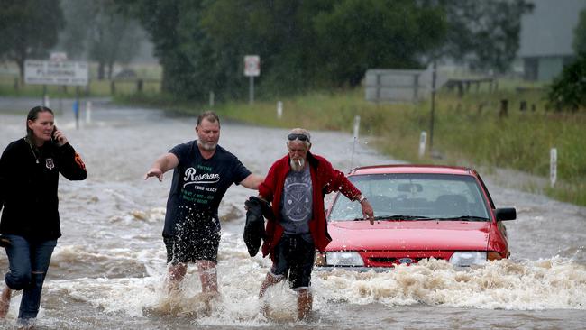 ....and is rescued by locals as it is inundated with flood water. Picture: Nathan Edwards