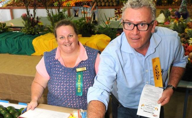 Steward Marianne Wyllie helps judge Stephen Wirtz select the best beans at the Gympie Show. Picture: Craig Warhurst