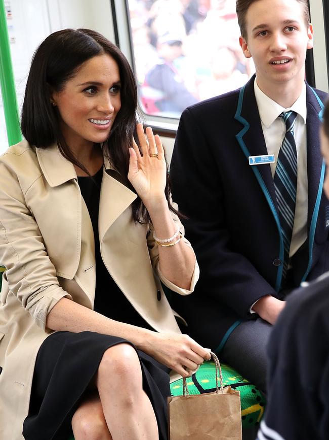 Meghan, Duchess of Sussex talk to students on a train through South Melbourne. Picture: Getty