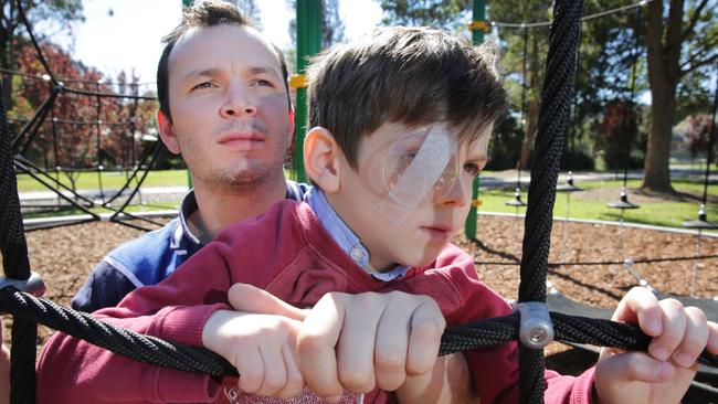 Simon Adnam-Berry with 6-year-old son Peter who almost lost one eye after a magpie attacked him piercing his eye at East Gosford. He had to have surgery and has lost some sight. Picture: Mark Scott