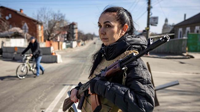 A volunteer takes position at a checkpoint in a district of Kyiv. Picture: AFP