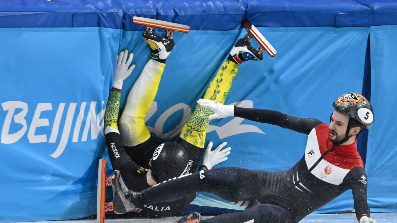 Australia's Brendan Corey and Netherlands' Itzhak De Laat crash into a barrier during a quarter-final heat. Picture: AFP.