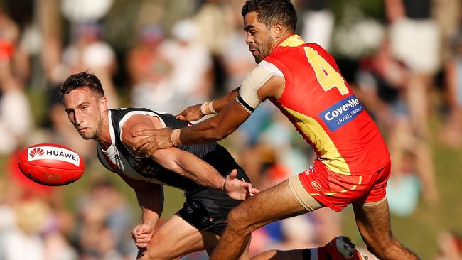 Luke Dunstan jostles with Gold Coast’s Jack Martin during Saturday’s clash in Townsville. Picture: Michael Willson/AFL Photos via Getty Images.