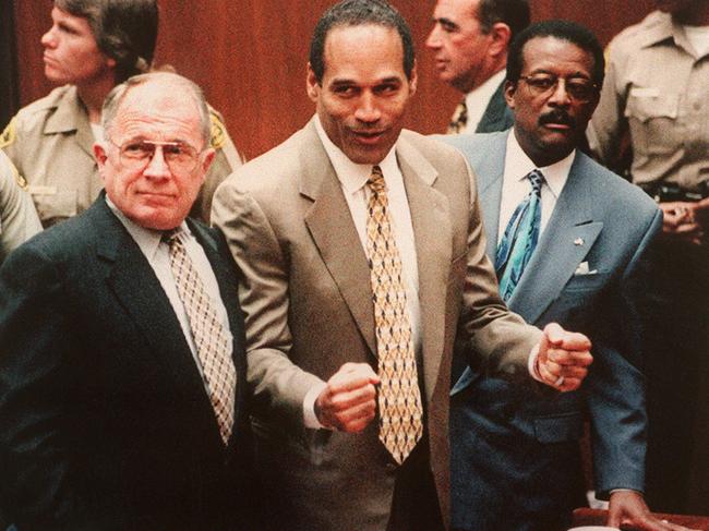 Defendant O.J. Simpson (C) cheers while standing with his attorneys F. Lee Bailey (L) and Johnnie Cochan Jr (R), after hearing the not guilty verdict in his criminal murder trial. Picture: Agence France Presse/Getty Images