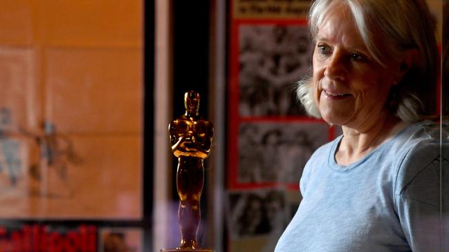 Museum of Tropical Queensland Manager, Programming and Engagement Claire Speedie with the Academy Award on display at part of the Action! Film and War exhibition. Picture: Evan Morgan