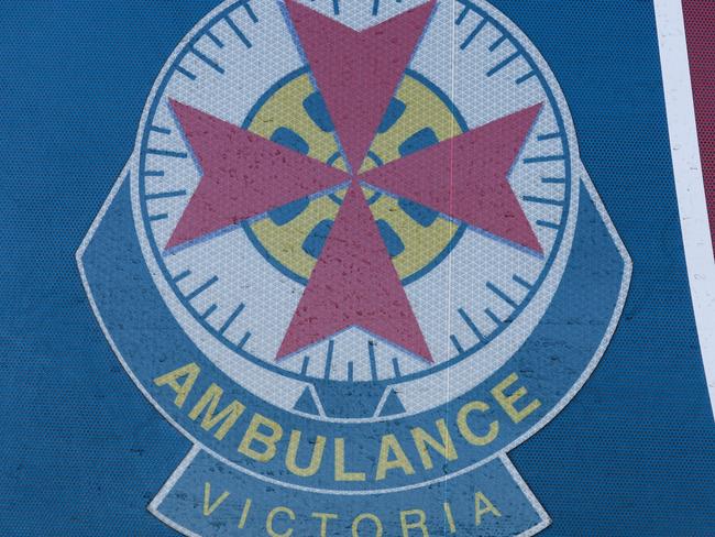 MELBOURNE, AUSTRALIA - JULY 21: The Ambulance Victoria logo is seen on the side of an ambulance at the Royal Melbourne Hospital on July 21, 2022 in Melbourne, Australia. Victoria recorded 14,312 official cases of COVID-19 in the last 24-hour reporting period, with 875 people hospitalised with the virus, including 46 in intensive care. 37 deaths were also included in this reporting period. While the Federal government has not implemented any COVID-19 restrictions in response to the latest COVID-19 wave, concerns over rising cases of the Omicron subvariants across Australia have seen health authorities recommend the use of face masks indoors, and for people to work from home where possible. (Photo by Asanka Ratnayake/Getty Images)