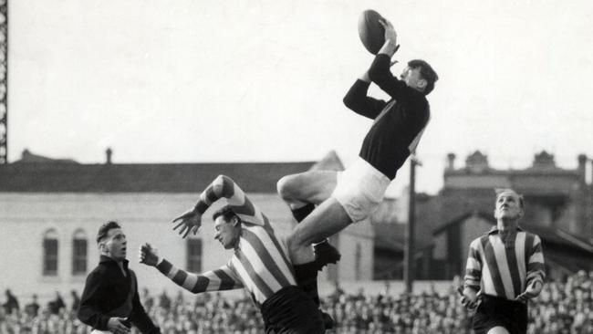 Essendon’s John Coleman marks over North Melbourne’s Vic Lawrence in a 1953 VFL match.