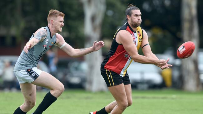 Goodwood Saints ruckman Tom Carter gets a handball off during a clash against Port District this season. Carter has been the Saints’ best this year. Picture: Naomi Jellicoe