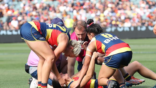 ADELAIDE, AUSTRALIA – APRIL 17: Angela Foley of the Crows is attended to after sustaining an injury during the 2021 AFLW Grand Final match between the Adelaide Crows and the Brisbane Lions at Adelaide Oval on April 17, 2021 in Adelaide, Australia. (Photo by Sarah Reed/AFL Photos via Getty Images)