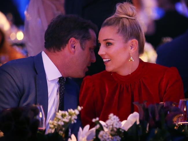 Stefanovic whispers into his girlfriend’s ear as they watch on at the David Jones Spring/Summer fashion parade.