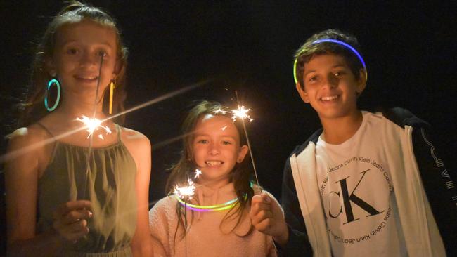 Zahli, Kaleb and Maya (no surnames given) celebrating New Year's Eve 2022 at Mooloolaba. Photo: Elizabeth Neil