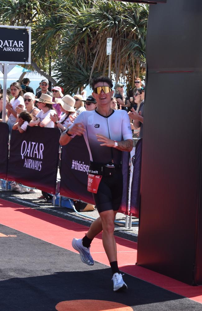 Athletes crossing the finish line at the Sunshine Coast Ironman 70.3 2023.