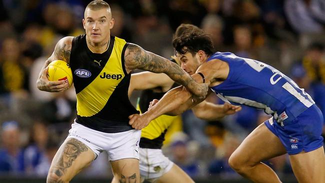 Dustin Martin tries to break away.