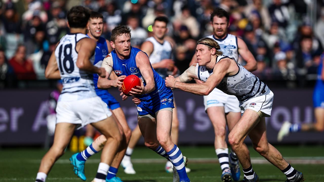 North Melbourne’s Jack Ziebell is tackled by Mark Blicavs in round 17 at GMHBA Stadium. Picture: Dylan Burns/AFL Photos via Getty Images.