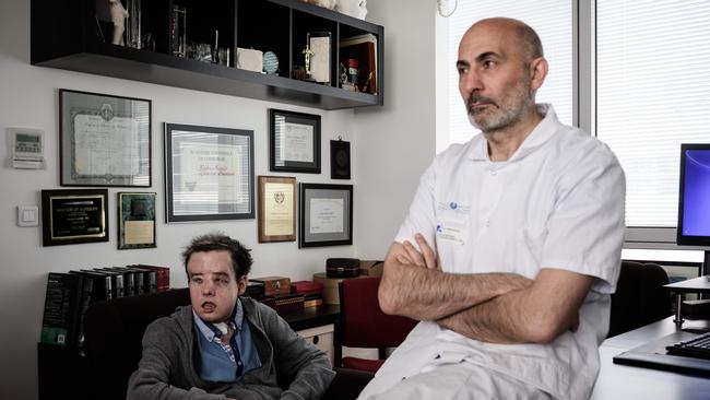 French medicine professor Laurent Lantieri (R), a specialist in hand and face transplant, poses with his patient Jerome Hamon.