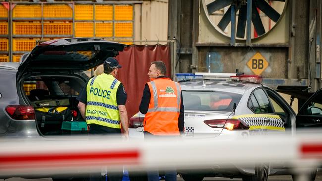 Police and SafeWork SA personal at the scene. Picture: Mike Burton