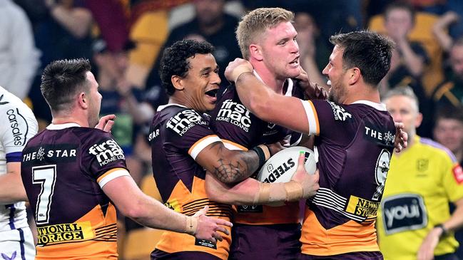 BRISBANE, AUSTRALIA - AUGUST 31: Tom Flegler of the Broncos is congratulated by team mates after scoring a try during the round 27 NRL match between the Brisbane Broncos and Melbourne Storm at Suncorp Stadium on August 31, 2023 in Brisbane, Australia. (Photo by Bradley Kanaris/Getty Images)