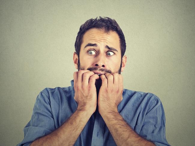 Portrait anxious young man biting his nails fingers freaking out, frightened, generic, scared