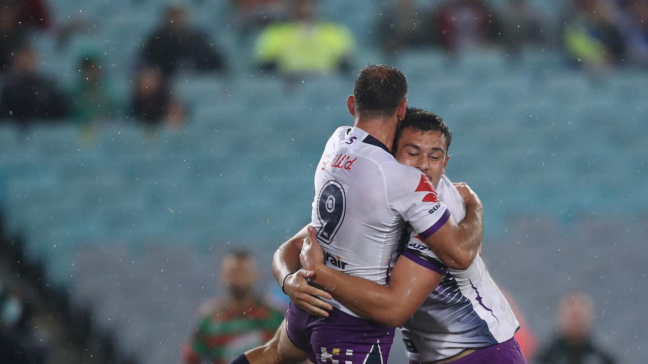 Melbourne's Cameron Smith celebrates a try by Melbourne's Tino Faasuamaleaui.