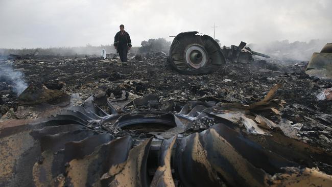 An Emergencies Ministry member walks at a site of a Malaysia Airlines Boeing 777 plane crash near the settlement of Grabovo in the Donetsk region, July 17, 2014. The Malaysian airliner flight MH17 was brought down over eastern Ukraine on Thursday, killing all 295 people aboard and sharply raising the stakes in a conflict between Kiev and pro-Moscow rebels in which Russia and the West back opposing sides. REUTERS/Maxim Zmeyev (UKRAINE - Tags: TRANSPORT DISASTER POLITICS CIVIL UNREST TPX IMAGES OF THE DAY) - GM1EA7I08OT01