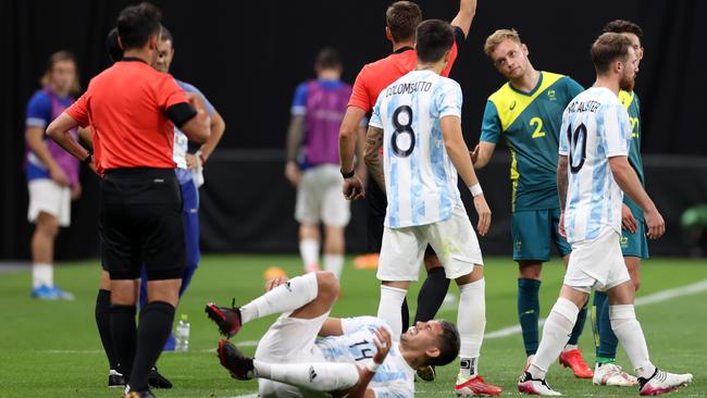 SAPPORO, JAPAN - JULY 22: Nathaniel Atkinson #2 of Team Australia is shown a yellow card by Match Referee, Srdan Jovanovic during the Men's First Round Group C match between Argentina and Australia during the Tokyo 2020 Olympic Games at Sapporo Dome on July 22, 2021 in Sapporo, Hokkaido, Japan. (Photo by Masashi Hara/Getty Images)