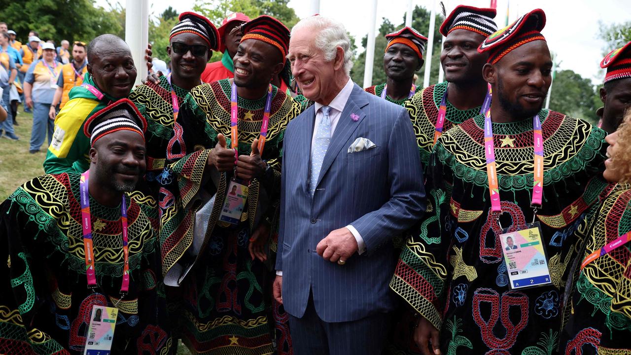 Prince Charles with members of the Cameroon team at the Athletes’ Village. Picture: Phil Noble/AFP)