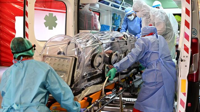 Medical staff transfer A COVID-19 patient in a bio-containment stretcher at the Garbagnate Milanaise hospital in Milan, Italy. Picture: AFP